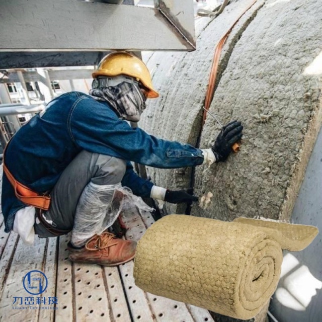 Worker installing flexible rock wool blanket on large curved industrial tank for high-temperature insulation - real application by Liluan Technology