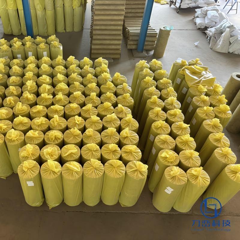 Large warehouse storage of pre-packaged rock wool pipe sections ready for steam piping insulation projects - Liluan Technology