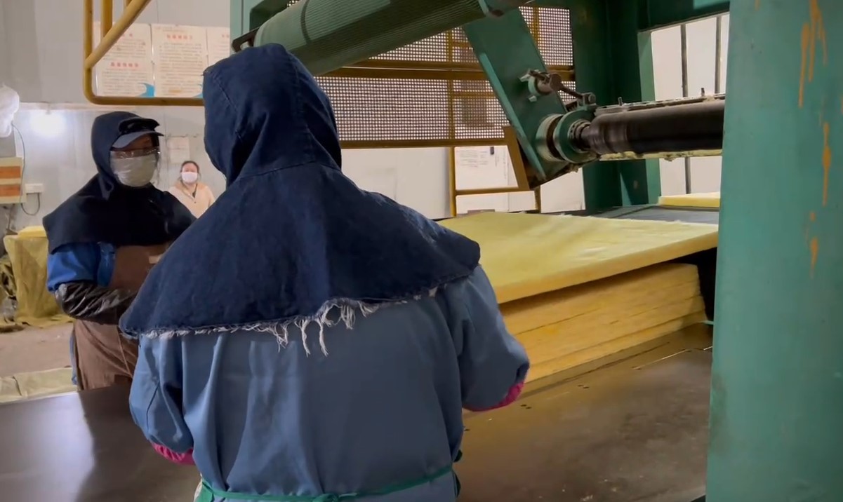 Worker overseeing glass wool board on production line – lightweight thermal and acoustic insulation manufacturing process by Liluan Technology