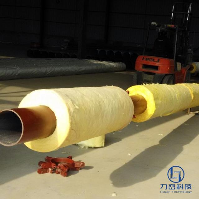 Long glass wool pipe section with red clamp ready for installation, forklift in background – industrial thermal insulation by Liluan Technology