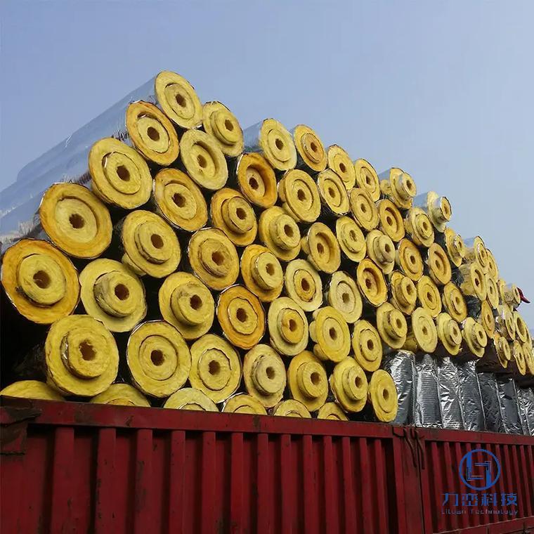 Large shipment of glass wool pipe sections loaded on red container truck – preformed lightweight thermal & acoustic insulation ready for export by Liluan Technology