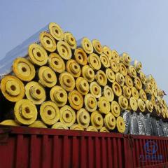 Large shipment of glass wool pipe sections loaded on red container truck – preformed lightweight thermal & acoustic insulation ready for export by Liluan Technology