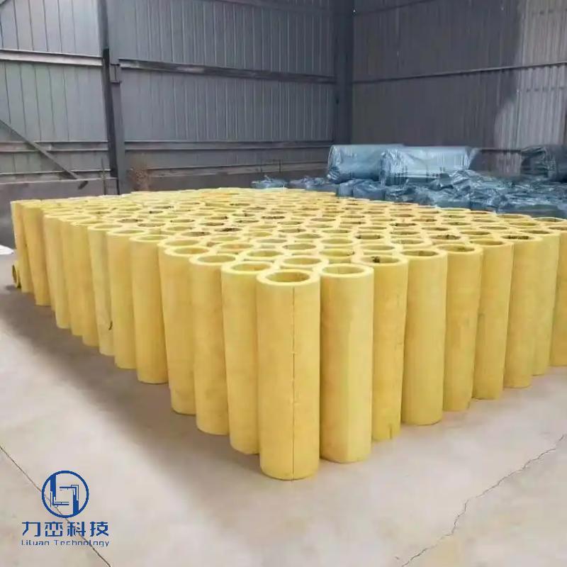 Hundreds of preformed glass wool pipe sections neatly arranged in warehouse – lightweight thermal & acoustic insulation stock by Liluan Technology