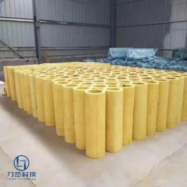 Hundreds of preformed glass wool pipe sections neatly arranged in warehouse – lightweight thermal & acoustic insulation stock by Liluan Technology