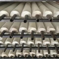 Long aluminum silicate pipes neatly stacked on metal racks in warehouse production line– industrial high-temperature pipe insulation by Liluan Technology