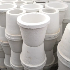 Stacks of identical conical ceramic fiber special-shaped parts, likely used as crucibles or flow distributors, neatly stacked together in a warehouse for bulk supply——LiLuan Technology