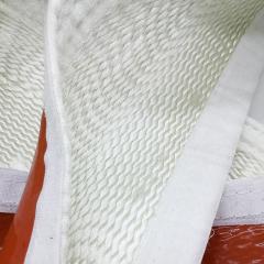 Close-up detail of the high-density white fiberglass weave and reinforced stitching of a buckle insulation sleeve, highlighting the heavy-duty hook-and-loop fastening edge---LiLuan Technology