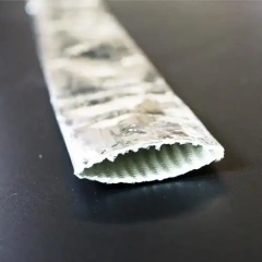 A roll of Liluan aluminum foil coated fiberglass sleeve presented horizontally with the end pressed flat, emphasizing its flat width for easier wiring harness installation.---LiLuan Technology
