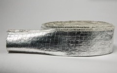 A detailed view of a roll of Liluan aluminum foil fiberglass sleeve under studio lighting, highlighting the fine texture of the reflective aluminum surface and the round opening.---LiLuan Technology