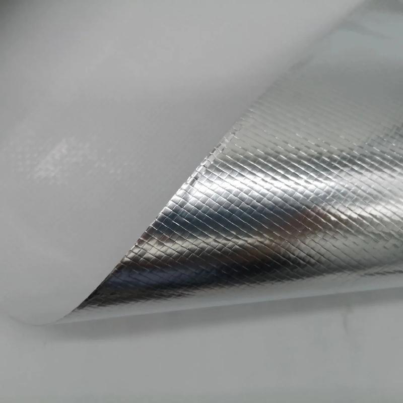Close-up view of a sample corner of Liluan aluminum foil glass Fiber cloth, with the edge slightly curled to reveal the white fiberglass base beneath the textured aluminum layer.---LiLuan Technology