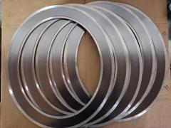 Bulk stock of stainless steel jacketed graphite gaskets on brown paper, industrial metal clad sealing gaskets for chemical and oil & gas flange sealing-LiLuan Technology