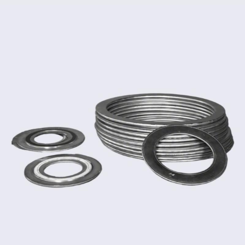 A catalog-style studio photograph on a clean white background showcasing a large, neat stack of armored stainless steel coated graphite gaskets. Several individual gaskets are also displayed to the left, demonstrating bulk supply capability for high-pressure industrial sealing.---LiLuan Technology