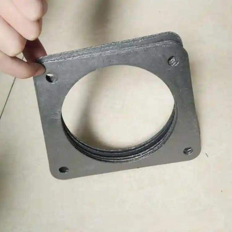 A close-up shot of a hand holding a square-shaped tanged reinforced graphite gasket, detailing the precise bolt holes and the specific square flange design, illustrating high-quality construction and easy handling.---LiLuan Technology