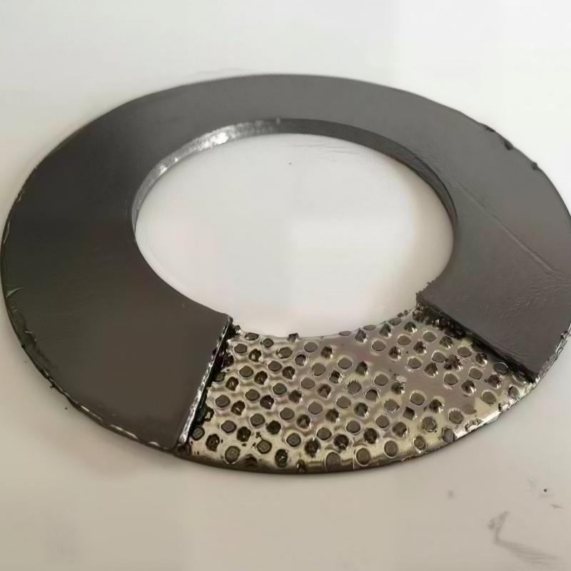 A detailed macro product view of a tanged stainless steel reinforced flexible graphite gasket, with a section partially peeled back to clearly reveal the internal serrated (tanged) metal reinforcement core, demonstrating its superior mechanical strength and sealability.---LiLuan Technology