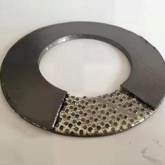 A detailed macro product view of a tanged stainless steel reinforced flexible graphite gasket, with a section partially peeled back to clearly reveal the internal serrated (tanged) metal reinforcement core, demonstrating its superior mechanical strength and sealability.---LiLuan Technology