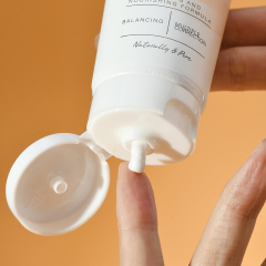 Person using Puramoria BHA Hyaluronic Acid Facial Cleanser, showing gentle application for deep cleansing.