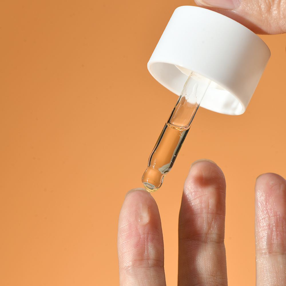 Person applying PURAMOIRA Hydrating Serum to face for deep hydration and skin brightening