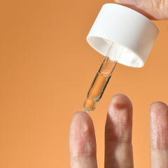 Person applying PURAMOIRA Hydrating Serum to face for deep hydration and skin brightening