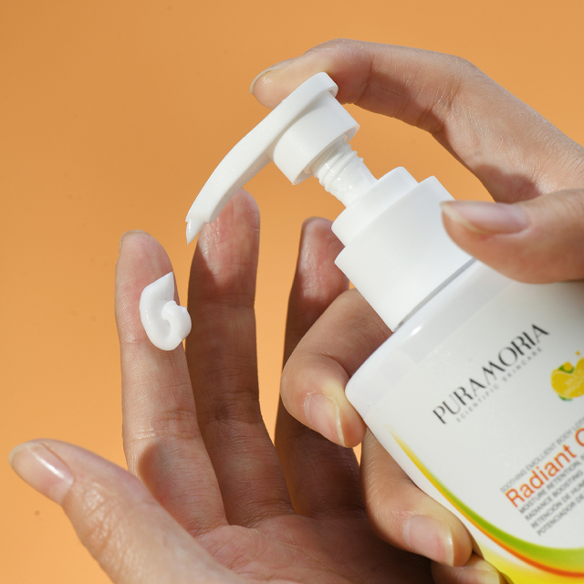 Close‑up of PURAMORIA Brightening Body Lotion texture in hand, creamy formula ideal for bulk order sampling