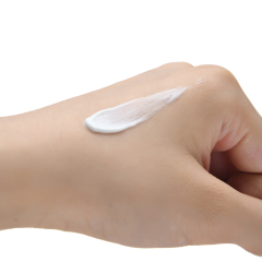 A close-up of the moisturizing, non-greasy cream texture of our private label Vitamin C sunscreen, demonstrating a comfortable feel ideal for daily use in mass-market lines.