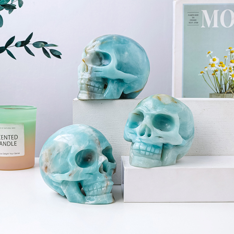 Natural crystal sky blue sky river stone skull carving piece original stone polished