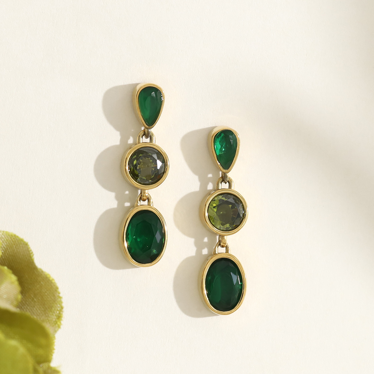 Stainless steel long stud earrings with teardrop-shaped emerald zircon stones