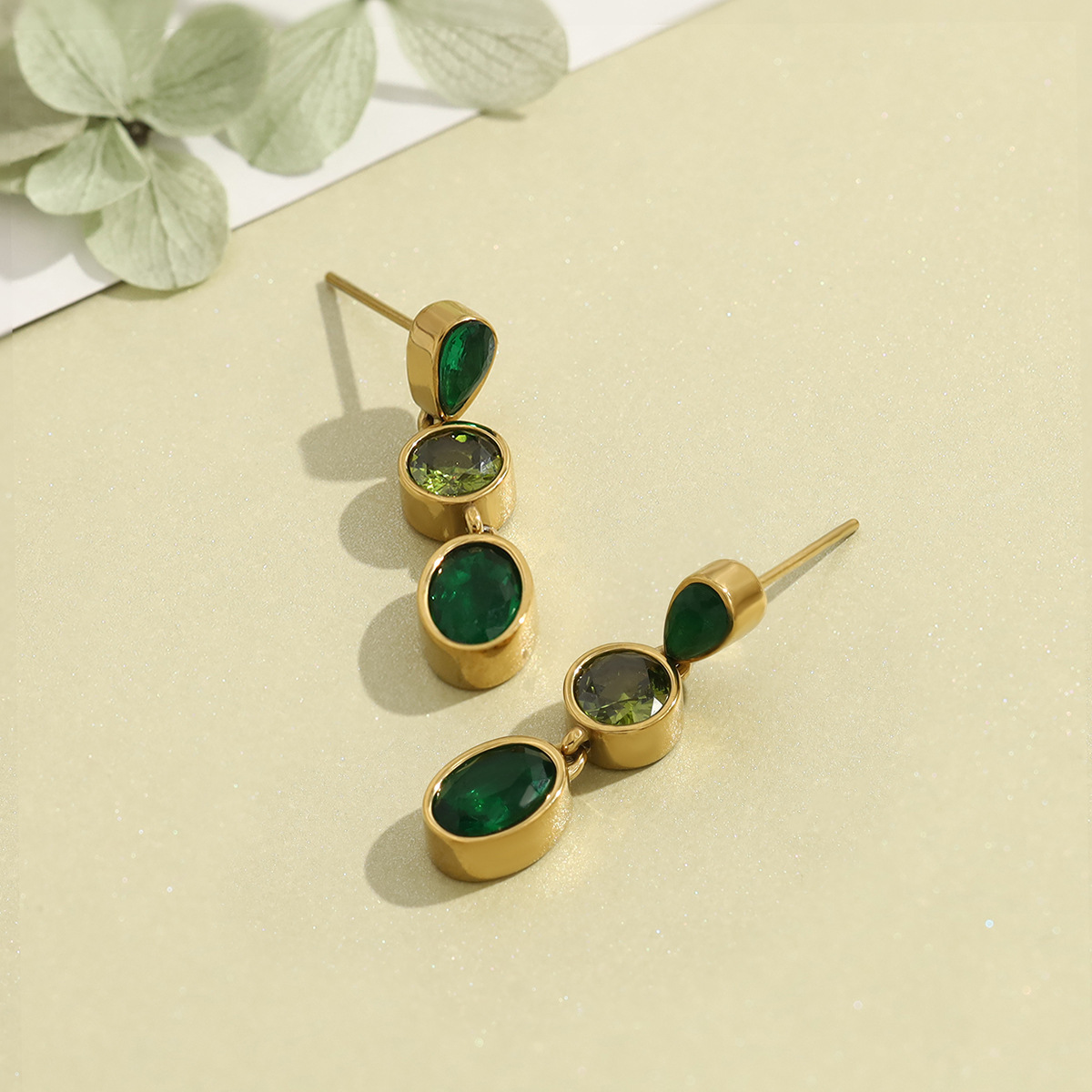 Stainless steel long stud earrings with teardrop-shaped emerald zircon stones