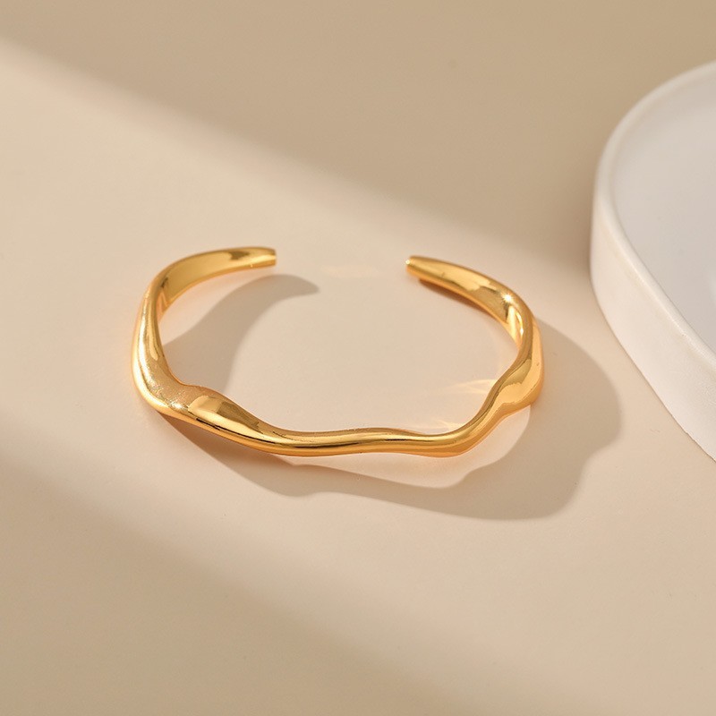 Minimalist copper bracelet with open design, stackable.