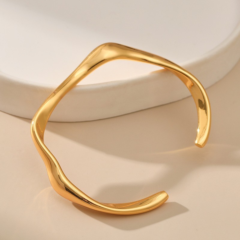 Minimalist copper bracelet with open design, stackable.