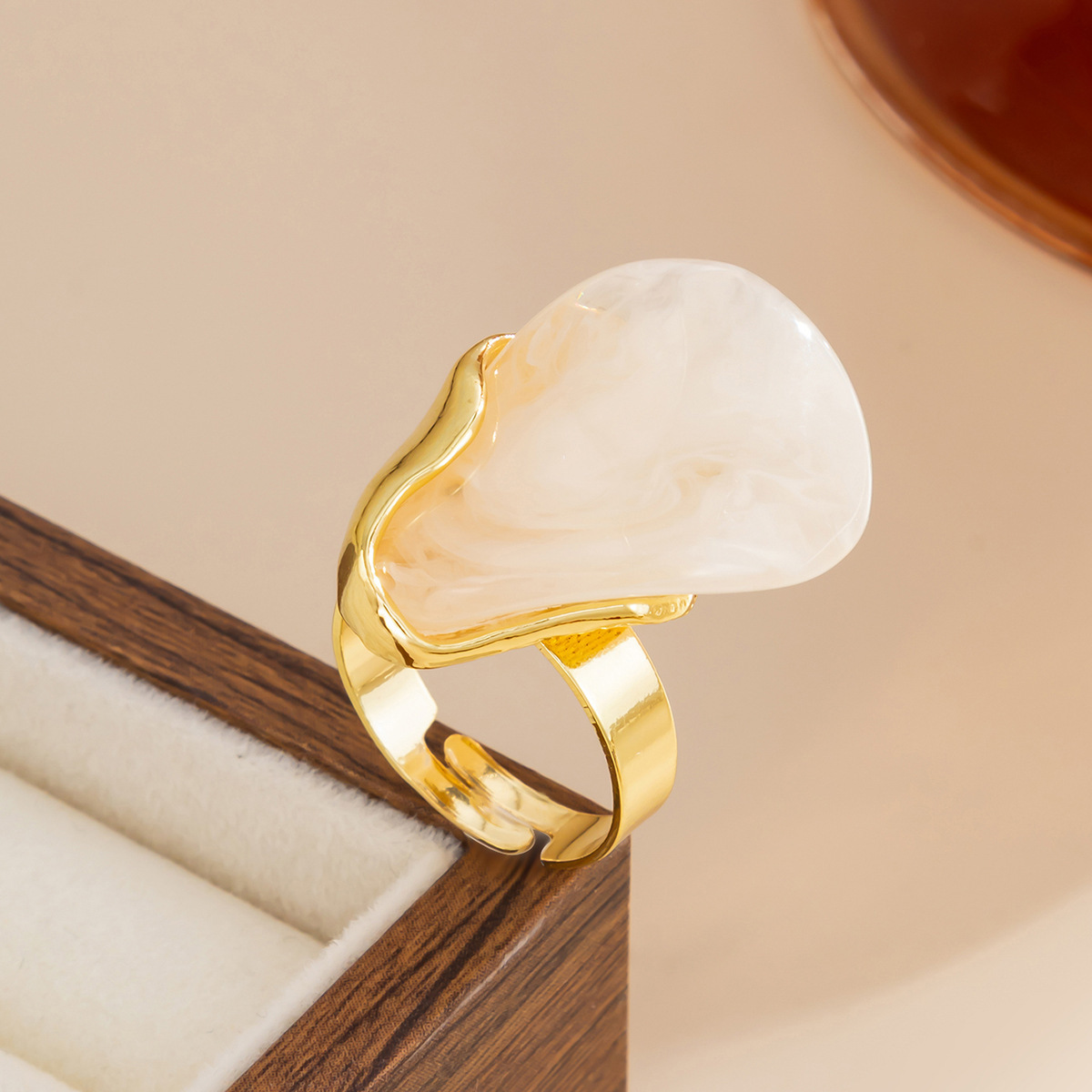 Irregularly shaped alloy resin ring with blurred patterns