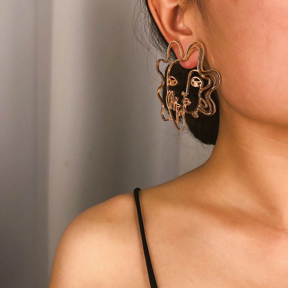 Hollowed-out 3D human face alloy earrings