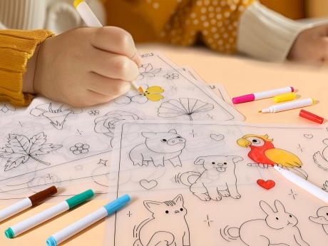 toddler practicing tracing fine motor skills on a reusable silicone drawing mat