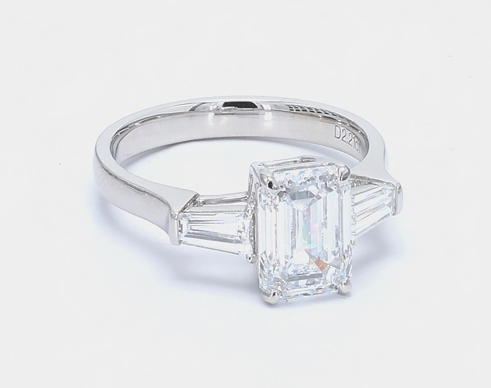 2.21 ct. Eternity Center Emerald Stone With 2 Trapezoid Side Stone Engagement Ring in polished white gold