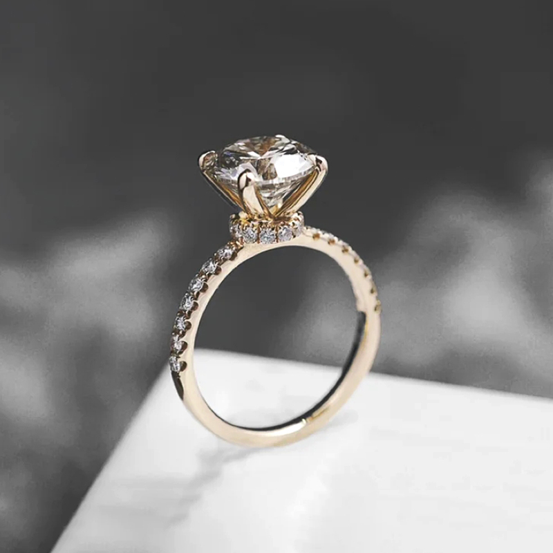 Four-prong diamond ring with half-circle setting