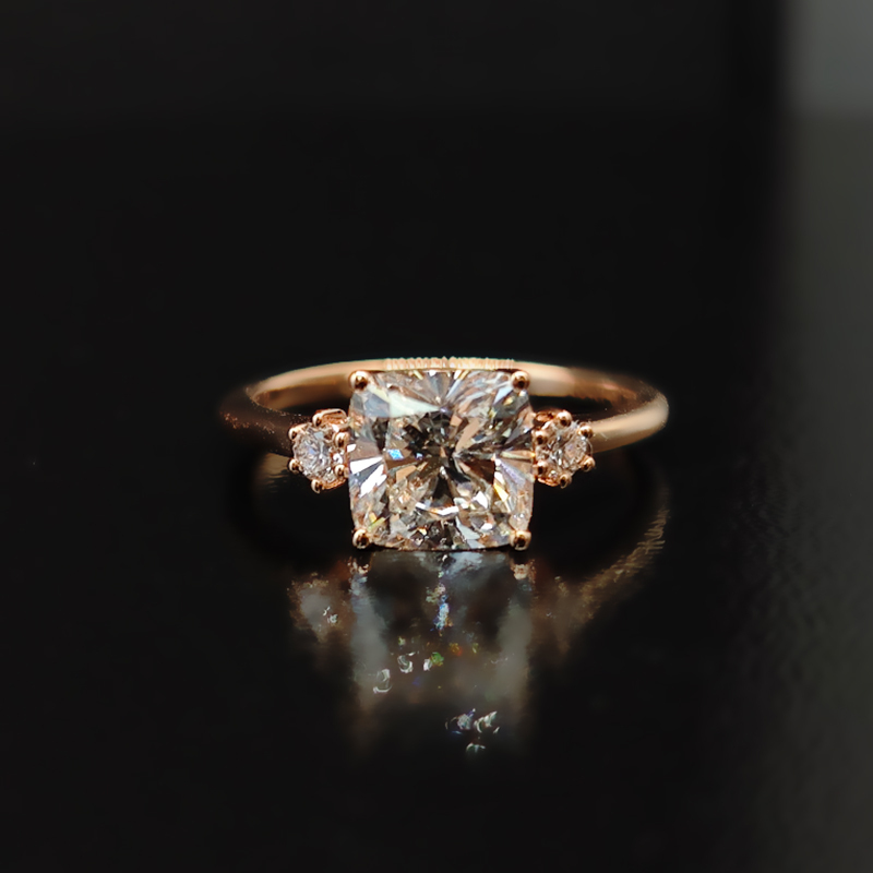 Cushion-cut diamond ring with three-life stone design