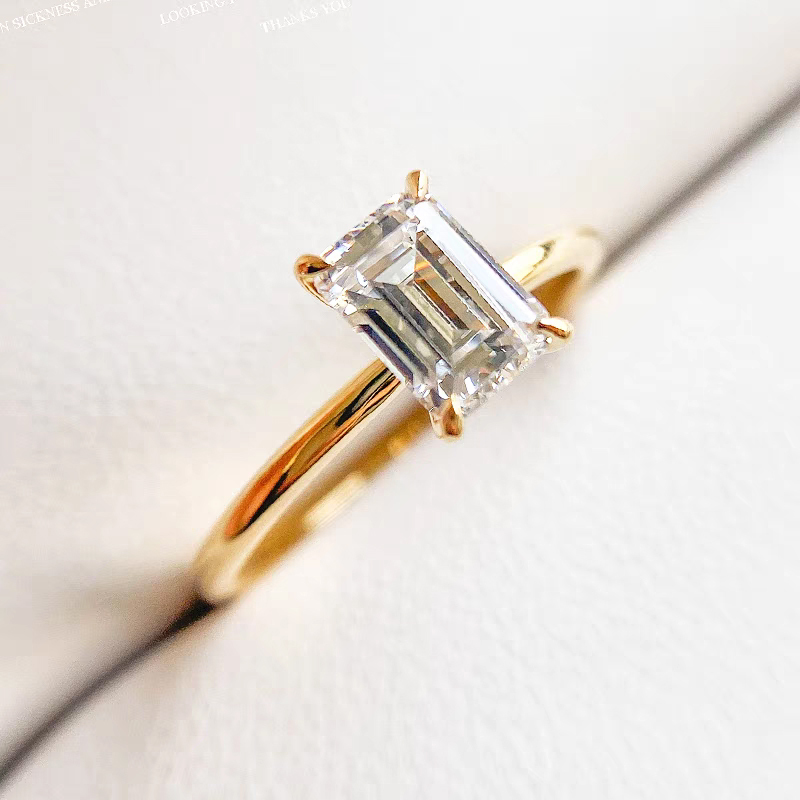 Emerald-cut diamond ring with a plain shank