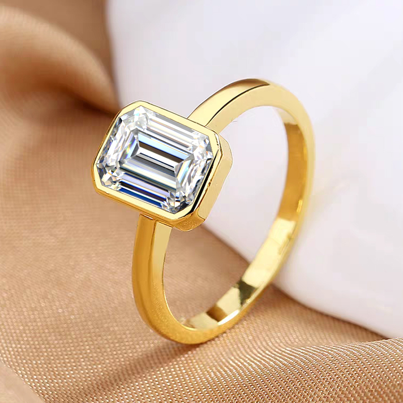 Emerald-cut diamond ring with bezel setting