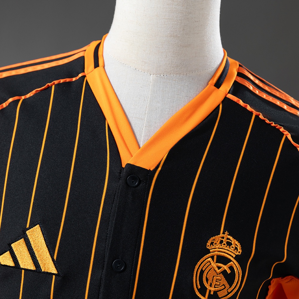 2025-26 REAL MADRID BLACK AND ORANGE US PACK FAN VERSION