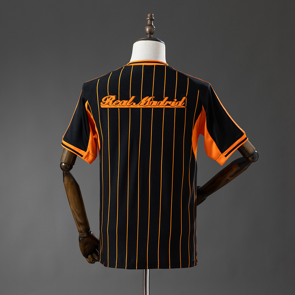 2025-26 REAL MADRID BLACK AND ORANGE US PACK FAN VERSION