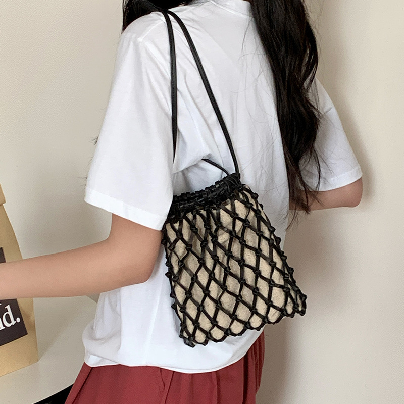 手工编织斜挎网兜包手机包女2025新款迷你抽绳福袋小包真皮渔网包