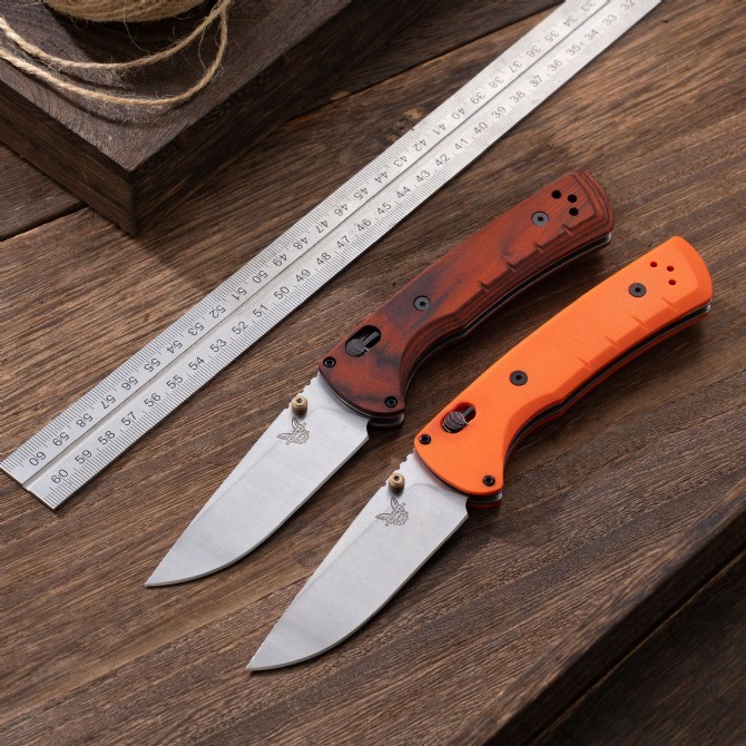 BM 15090 Hunt Bugout Axis Folding 3.46" Magnacut Clip Point Blade, G10/Dymondwood Handles