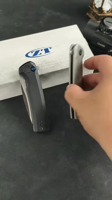 ZT 0044BLK Button Lock Flipper Knife 3.11" CPM-S45VN DLC Drop Point Blade, Titanium Handles
