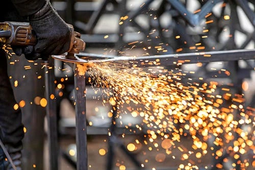 a worker is grinding the steel frame with Super F2 grinding wheel