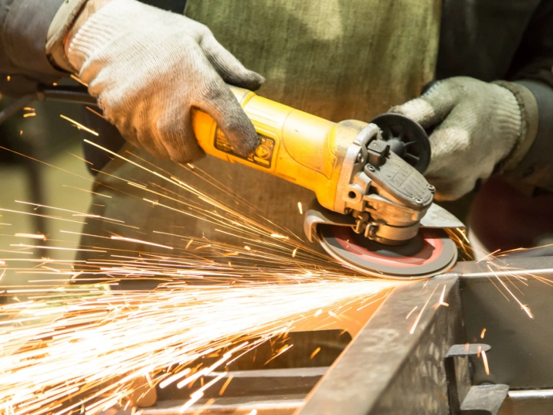 a worker is deburring the steel frame