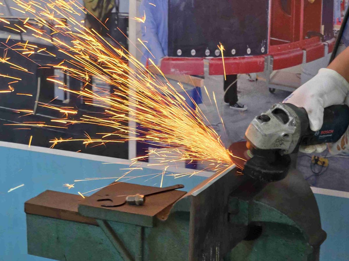 Close-up of Fuji grinding wheel removing weld seams on steel plates