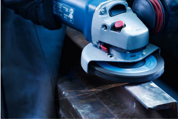Worker using FUJI grinding wheel on stainless steel structure