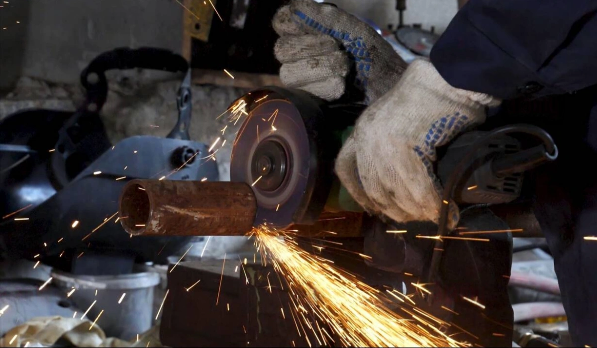 Worker cutting metal pipe with FUJI T1 Cut-Off Wheel