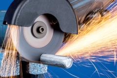 FUJI KIREMONO 4-inch cutting disc in action on an angle grinder, demonstrating a clean, fast cut on a steel bar.