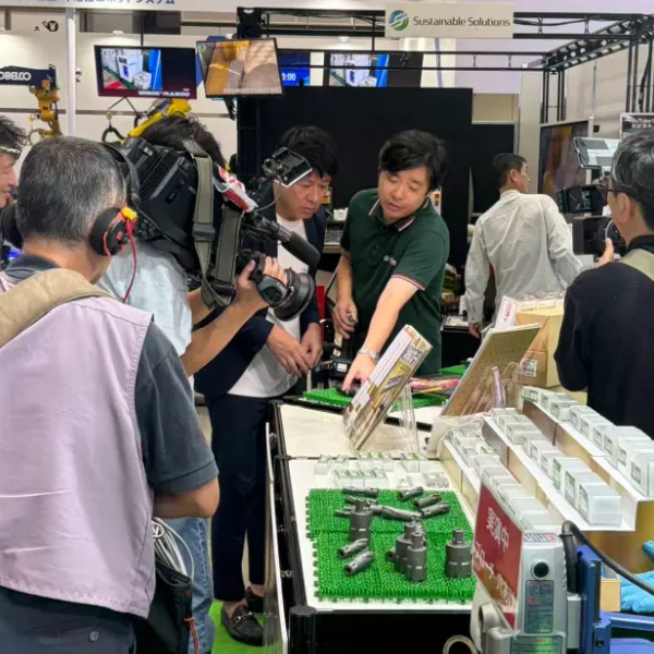 Japanese television crew filming a product explanation at the FUJI booth during Japan International Welding Show 2026