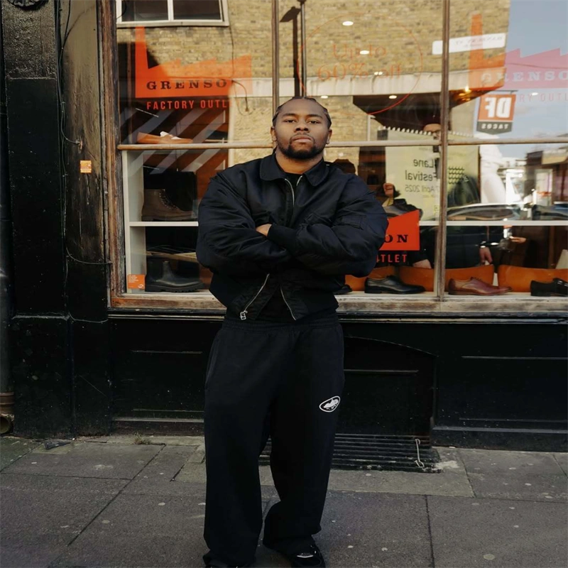 Black Corteiz Alcatraz Bomber Jacket shown in a streetwear outfit